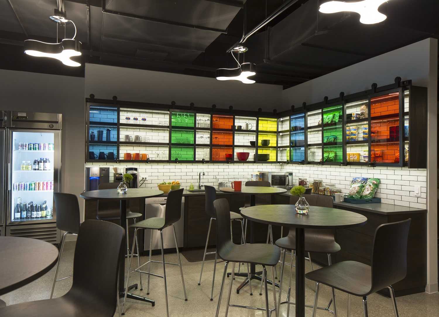 colorful break room with glass cabinets and seating