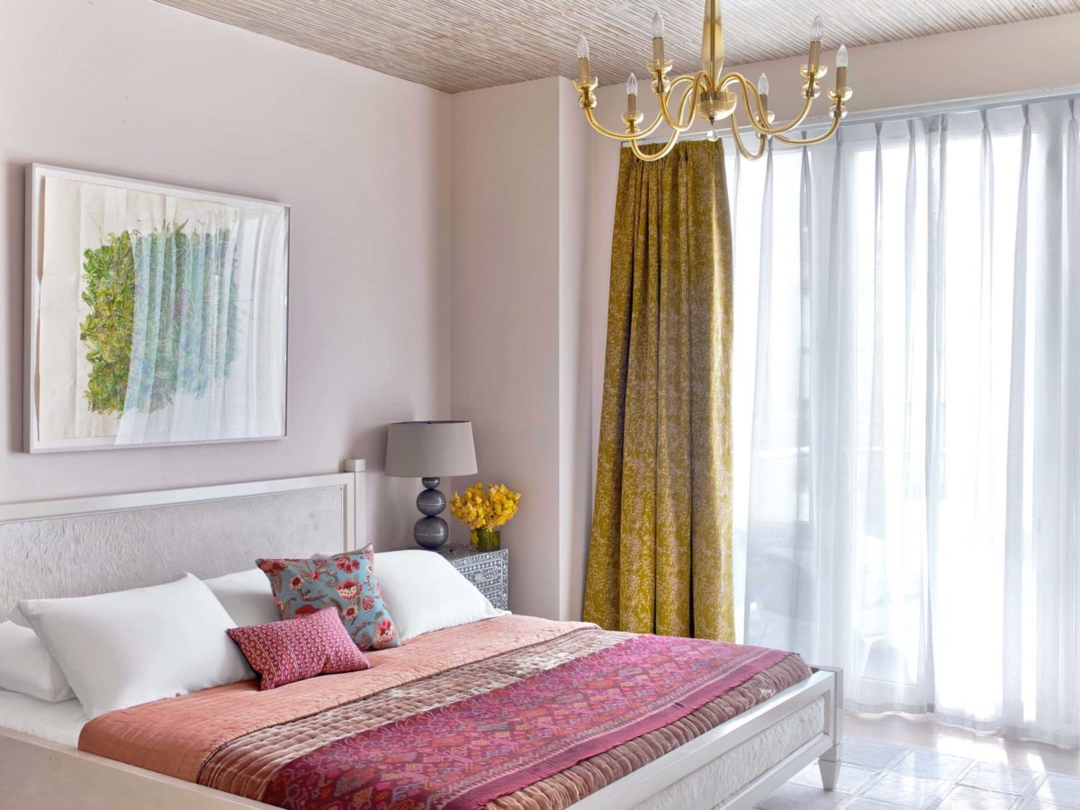 creamy chelsea bedroom with red bedding and gold curtains