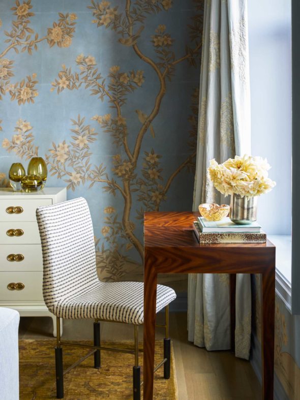calm glamorous blue bedroom with white desk chair and wooden desk