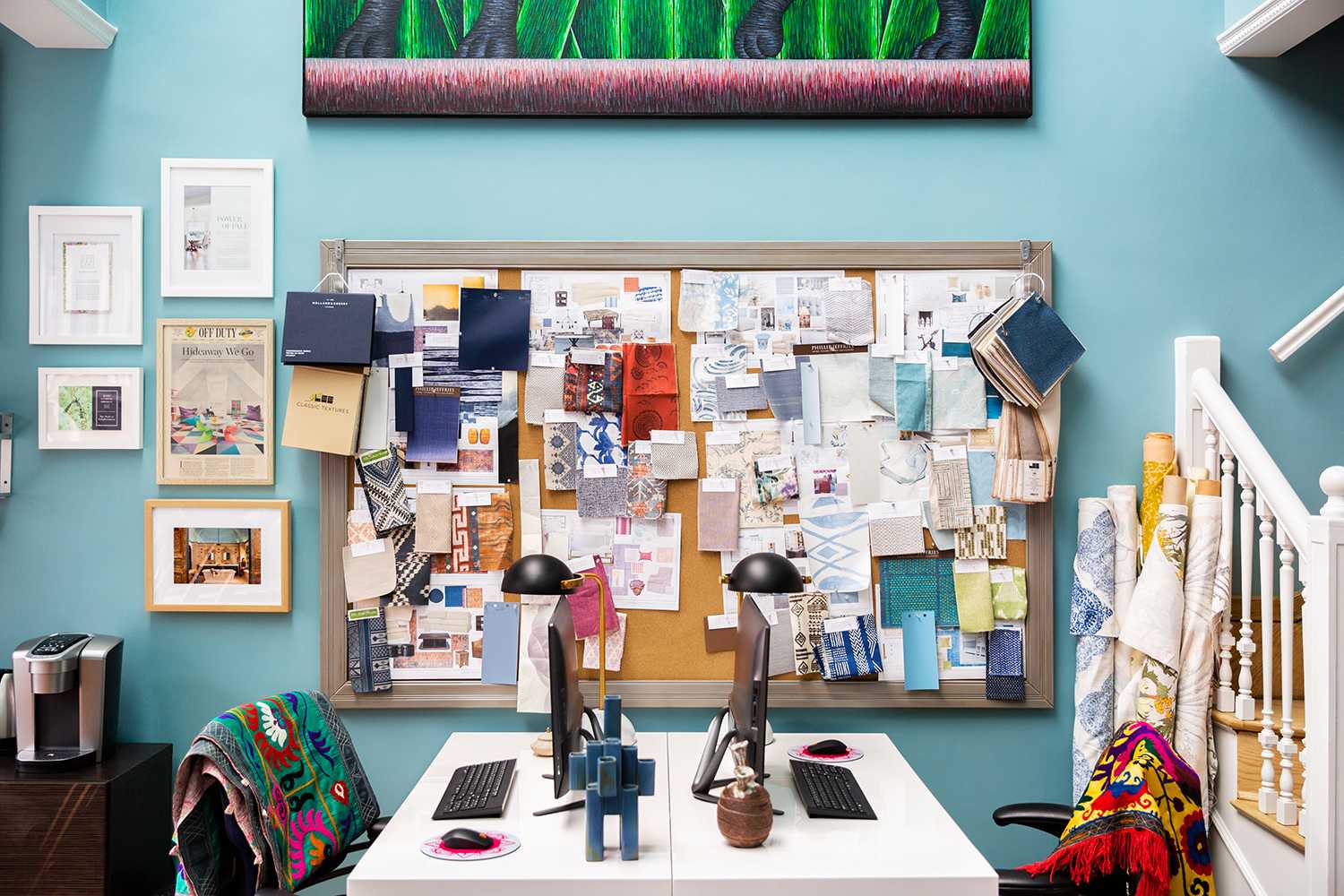 wide shot of desks and inspiration board on blue wall in Kati Curtis Design firm nyc