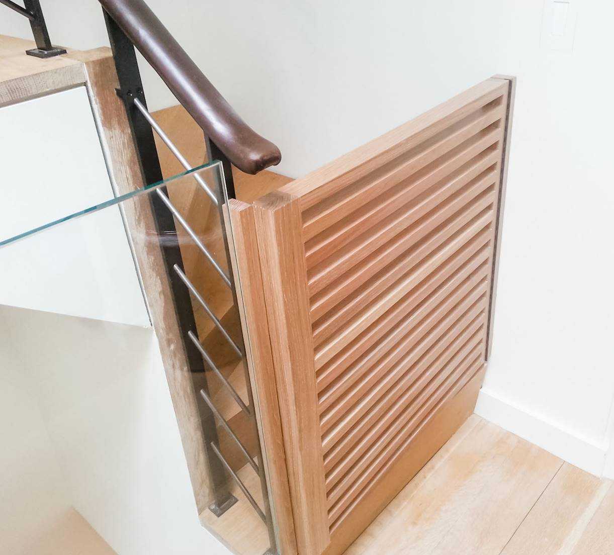 Integrated dog door made of wood on staircase