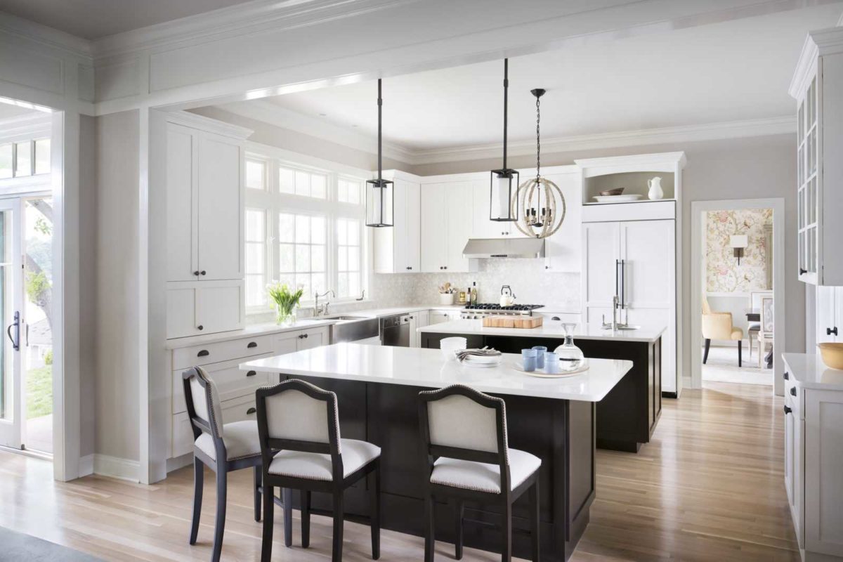 Large white kitchen with dark wood cabinets