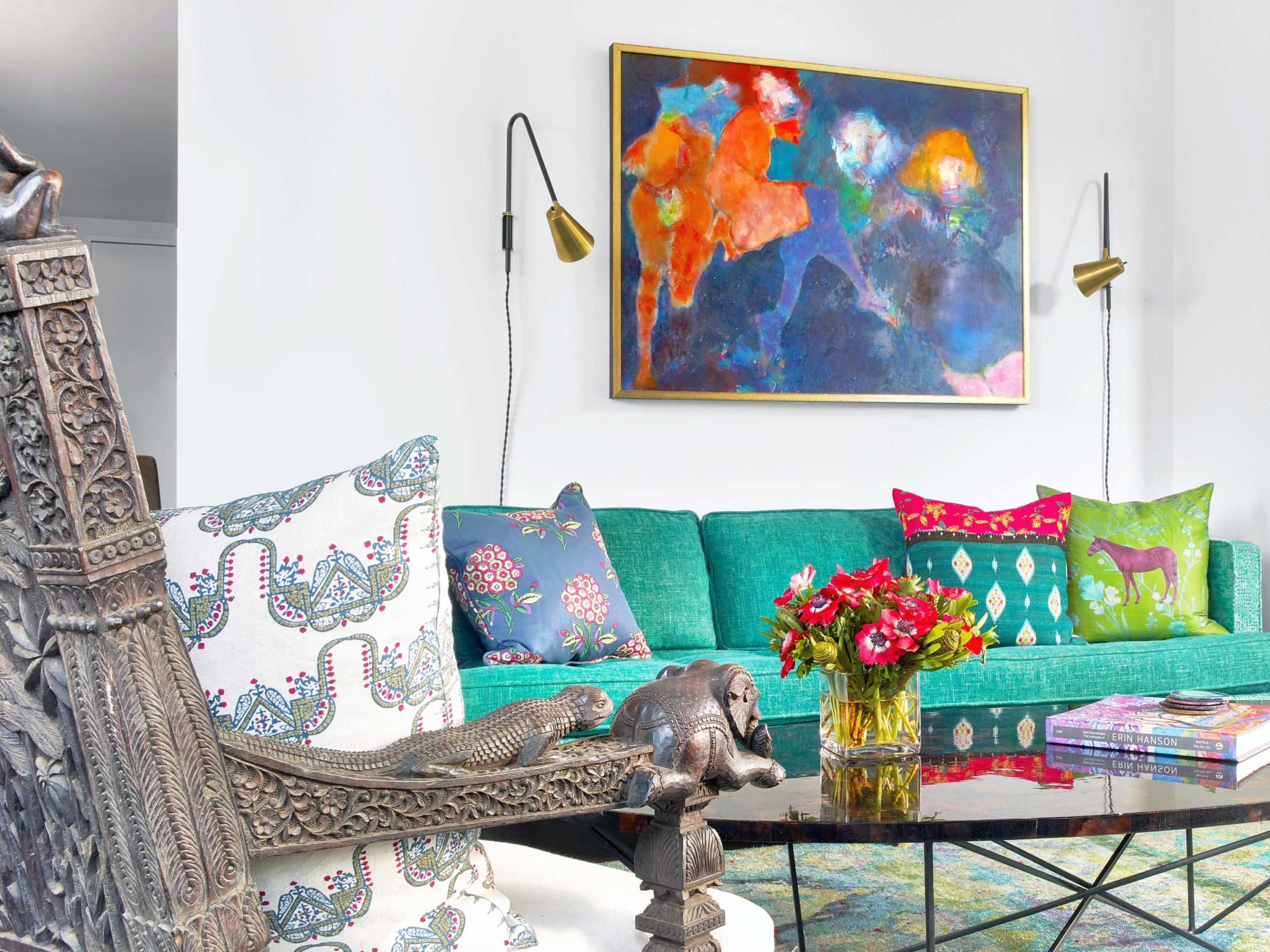 colorful decorative pillows on teal couch