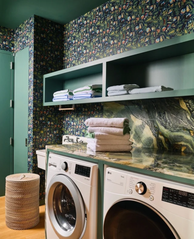 Even the laundry room deserves a little drama. ✨⁠
We wrapped this hardworking space in a storybook print, matched it to a deep green ceiling and millwork, and let a wildly veined stone countertop steal the scene. Proof that the most utilitarian rooms can feel like a tiny, opulent escape—one folded towel at a time.⁠